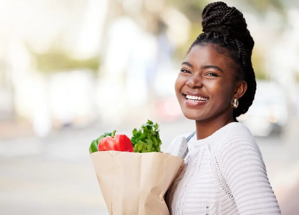 Shot of a young woman making her way home after grocery shopping